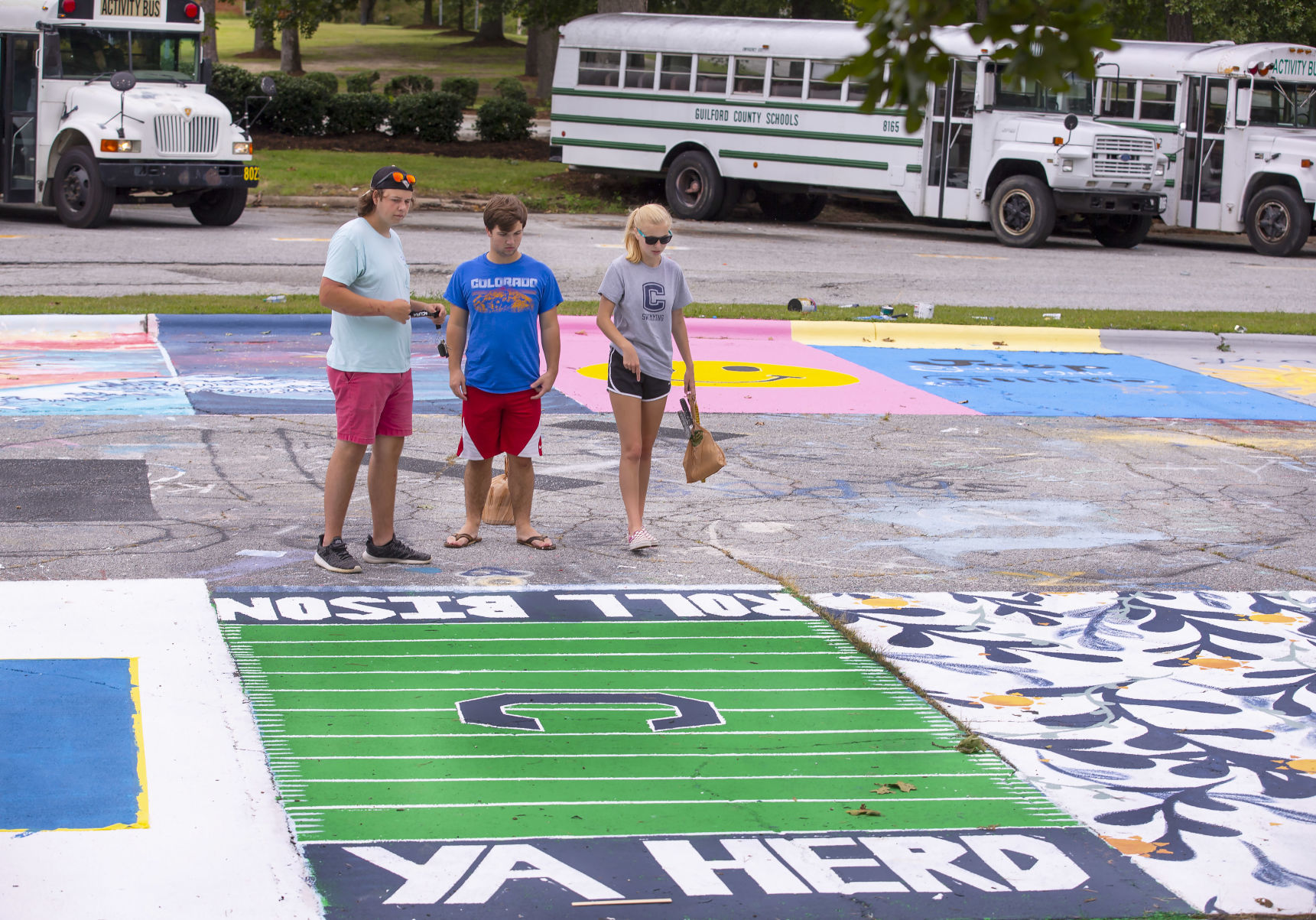 Students painting their parking spaces